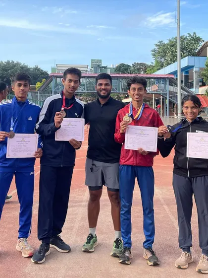 Our junior champs from the CISCE Regional State Athletic Meet, showcasing their medals with their coach.