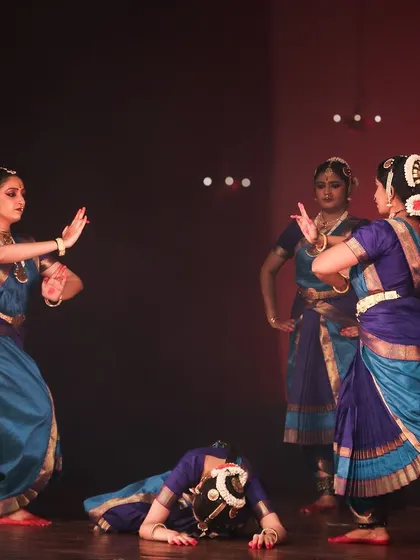 A moment of dramatic storytelling within the group choreography.