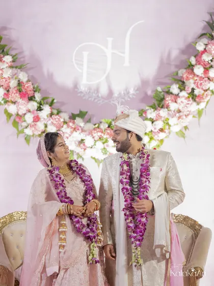 A sweet moment between the newlyweds, framed by their floral backdrop and custom monogram. We always look for ways to incorporate personal details into our shots.