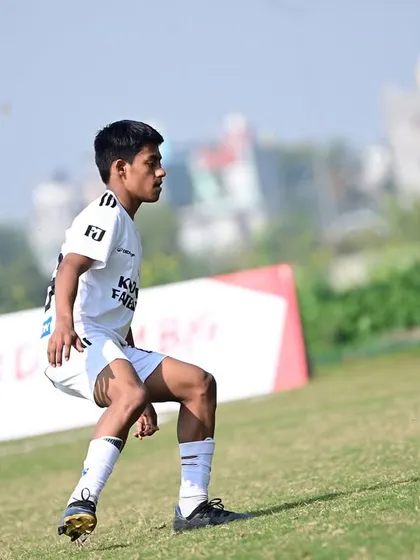A player controlling the ball with precision during a match. This demonstrates the technical proficiency we instill in our academy players.