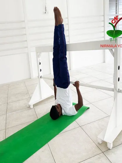 Here is Sarvangasana (Shoulderstand) being performed with a prop. This setup ensures the posture is comfortable and perfectly aligned, maximizing the benefits for thyroid health, sleep, and managing PCOD.
