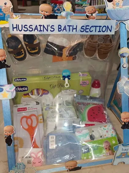 'Hussain's Bath Section', packed with baby bath products, towels, nail clippers, and shoes.
