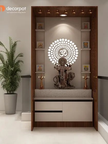 This pooja unit is framed in dark wood and features a stunning backlit Om mandala. The design includes multiple shelves for idols and integrated drawers for storage.