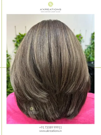 Ash brown highlights provide the perfect touch of elegance and trend-forward style, shown here in a chic, layered bob.