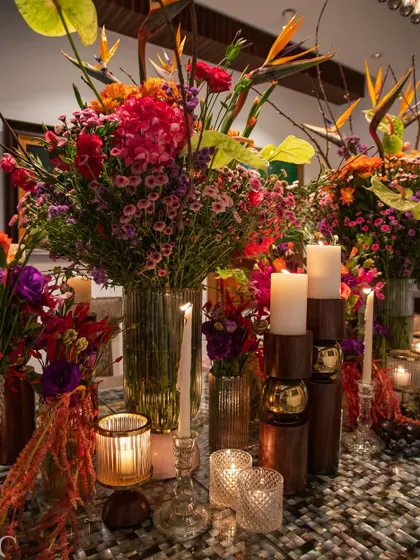 A magnificent floral arrangement bursting with a symphony of colors. Featuring Birds of Paradise, vibrant pink hydrangeas, and a mix of jewel-toned blooms, this piece is a celebration of nature's diversity and beauty.