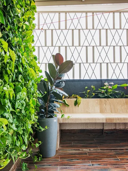 A vertical garden, or 'green wall', is a fantastic way to bring lushness to a terrace without sacrificing floor space. This one at the 'Opulent Abode' adds a vibrant backdrop to the seating area.