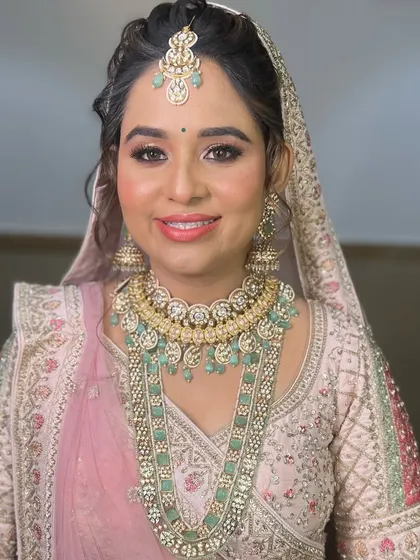 A beautiful example of pairing pastel jewellery with a pastel outfit. This bride is wearing my layered mint green and pearl set with her light pink wedding lehenga.