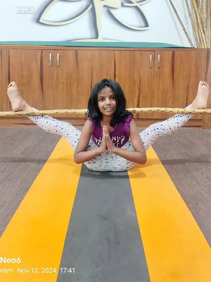 Using a prop to explore a deep stretch in this wide-legged seated forward bend. Props help make poses more accessible and allow kids to safely explore their flexibility.