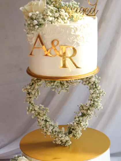 A full view of the floating heart engagement cake, showing how the two tiers are supported to create this unique and romantic illusion.