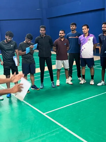 An instructor leads a practical session, with participants taking notes. My program emphasizes active observation and analysis, key skills for any effective badminton coach.