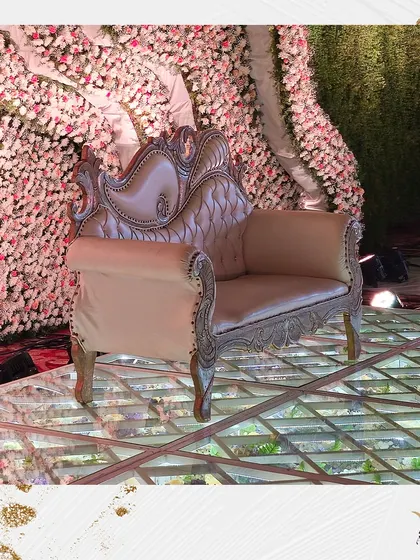 A close-up of the ornate seating on a glass floor filled with flowers. This highlights the luxurious details we incorporate to make every part of the decor special.