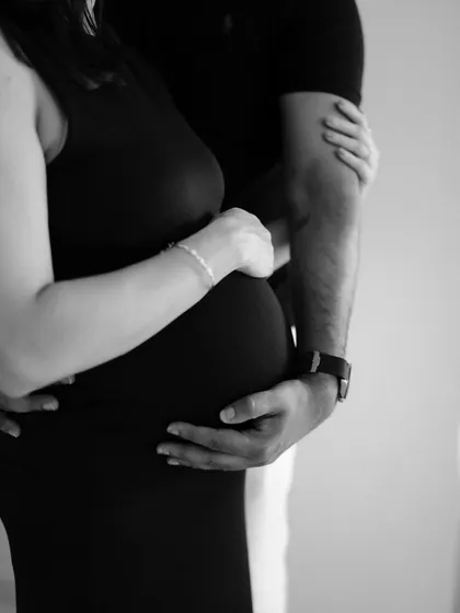 Sometimes, the most powerful stories are told in the details. This black and white close-up of their hands embracing the baby bump is timeless and full of emotion. It’s a simple, artistic shot that symbolizes protection, love, and connection.