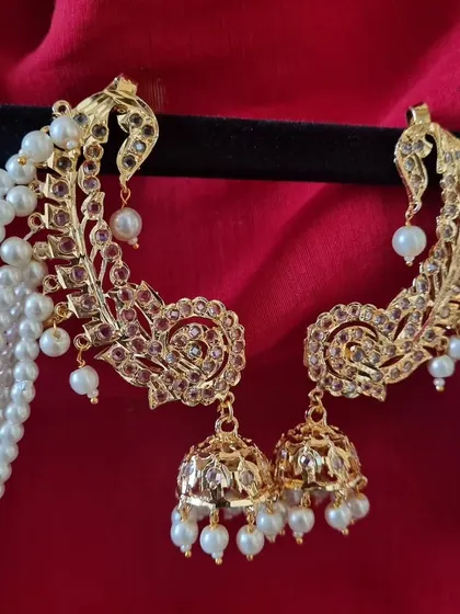 A close look at our gold-plated Hyderabadi Kimaya Earcuffs. Notice the intricate Jadau work and the cascade of pearls. This is a statement piece that blends royal heritage with modern craftsmanship, perfect for a bride or a wedding guest.