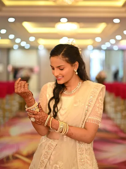Admiring the beautiful henna design while wearing one of my elegant rental lehengas. It’s these small moments that make a wedding so special.