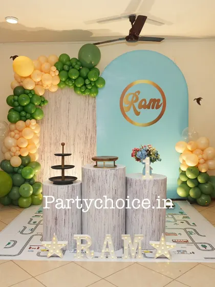 Another color variation for a boy's first birthday, using green and peach balloons for a softer look. The setup remains clean and modern.