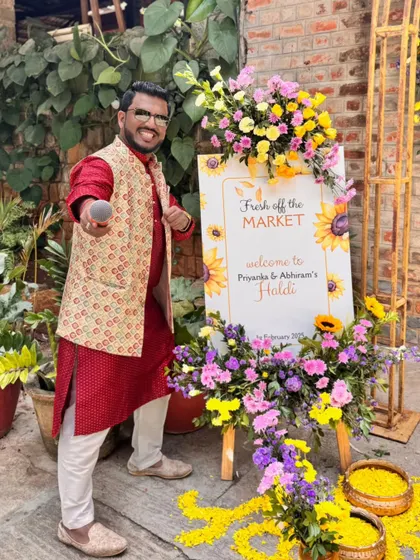 Posing by the 'Fresh off the Market' Haldi welcome sign. The fun starts from the moment guests walk in.