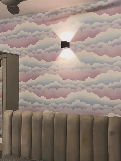 A dreamy cloud-patterned wallpaper in shades of pink, purple, and blue. This design adds a soft, whimsical touch to this bedroom.
