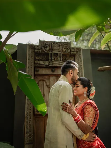 A quiet, intimate portrait framed by lush greenery. We use natural elements to create a sense of romance and tranquility in our couple's wedding photos.