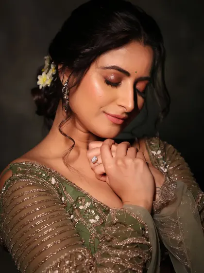 A moment of quiet reflection. This close-up shows the soft, shimmery eye makeup and the serene mood of this festive photoshoot.