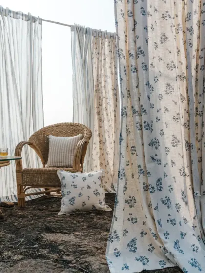 I believe your home should be a sanctuary. This outdoor setting from our 'Pause' collection, with its light-filtering sheers and floral cottons, captures the essence of the calm and natural beauty I strive to bring into every space.