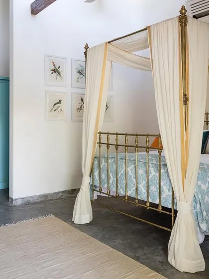 The interior of the Garden Suite at Jalakara, featuring a restored antique brass bed. We often mix old and new elements to give our spaces a sense of history and character.