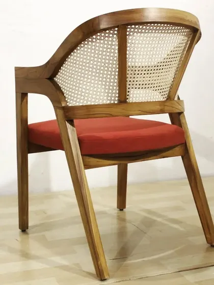 Cane and teak wood is a classic combination that is very popular right now. This armchair features a curved back with natural cane weaving, making it both stylish and comfortable. It’s a versatile design that works well in living rooms, bedrooms, or even cafes.