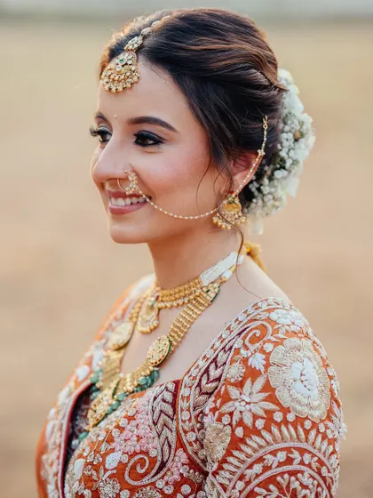 A radiant bridal portrait. Aditi's happy, glowing smile is the centerpiece of this beautiful close-up, capturing her joy on her wedding day.