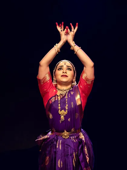 An expressive moment from Meera Krishna's recital, her hands forming a mudra that is central to the story.