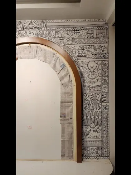 The left side of the arch, showing the balance and symmetry in the design, incorporating symbols like 'Om'.
