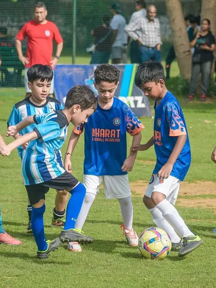 Even the youngest age groups get stuck in. Here, a group of U8 players swarm the ball, learning the fundamentals of teamwork.