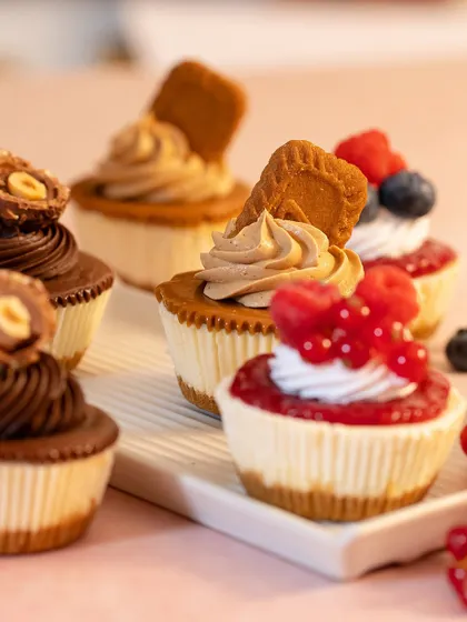 A different angle of my baby cheesecakes, showcasing the creamy texture and generous toppings. These bite-sized treats are always a crowd-pleaser.