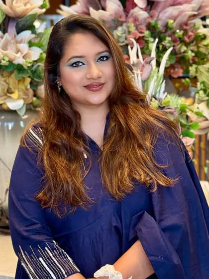 A confident and glamorous look featuring a bold pop of teal eyeshadow. The key to a statement eye is a clean blend and a luminous base, which makes the color stand out beautifully.