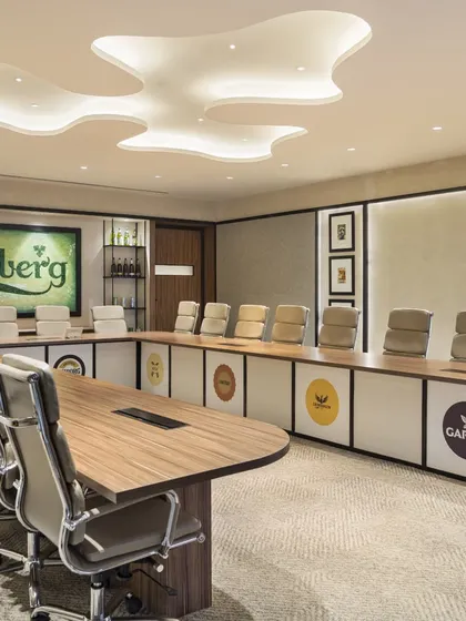 The final photograph of the Carlsberg boardroom, demonstrating the successful execution of the rendered concept. This builds trust by proving our commitment to delivering on our promises.