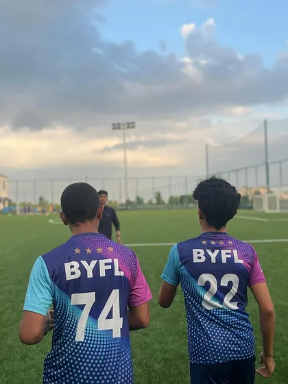 Two teammates jogging together, building a bond on and off the field.