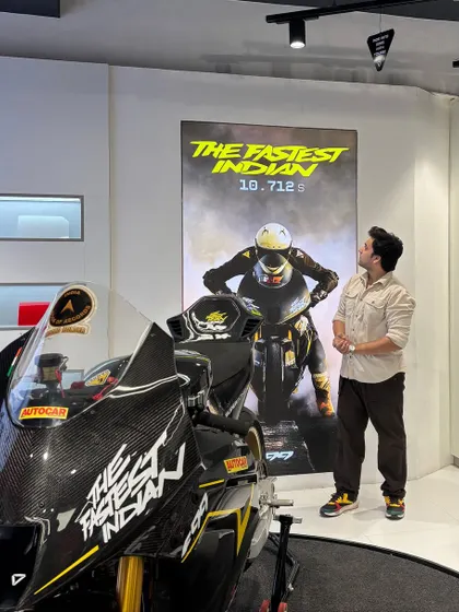 Admiring the record-breaking F99 bike at the Ultraviolette launch event. This shot places me as an aspirational figure alongside a premium product.