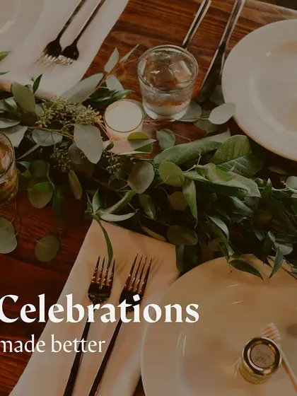 An elegant and simple table setting with a green garland, perfect for a sophisticated event.