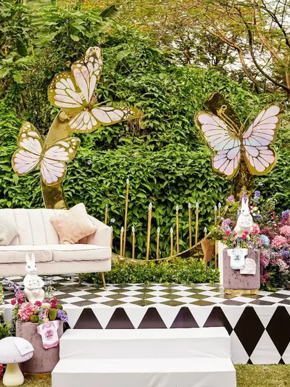 Another view of the main stage, highlighting the combination of the bold checkerboard pattern with soft, romantic florals and delicate butterfly cutouts.