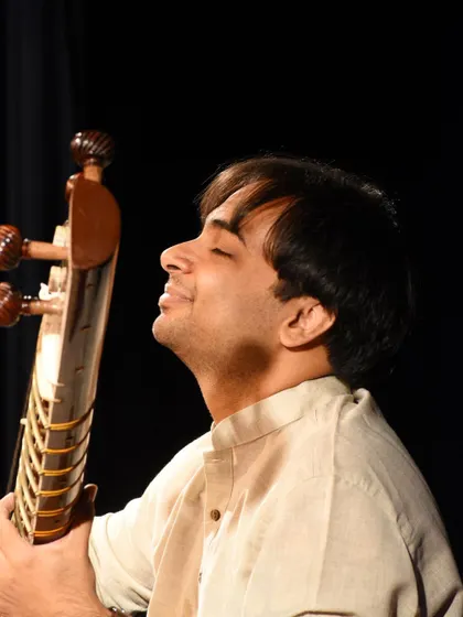 Lost in the music. This photo captures a moment of complete immersion in the sound of the sitar.