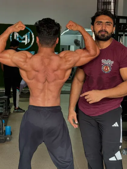 Checking out his back development. We've been working on adding thickness and width.