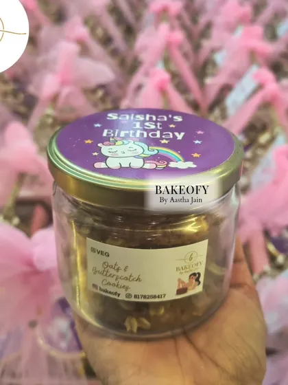 One of the items in the hamper: a jar of our freshly baked Oats & Butterscotch cookies, complete with a custom "Saisha's 1st Birthday" unicorn-themed lid sticker.