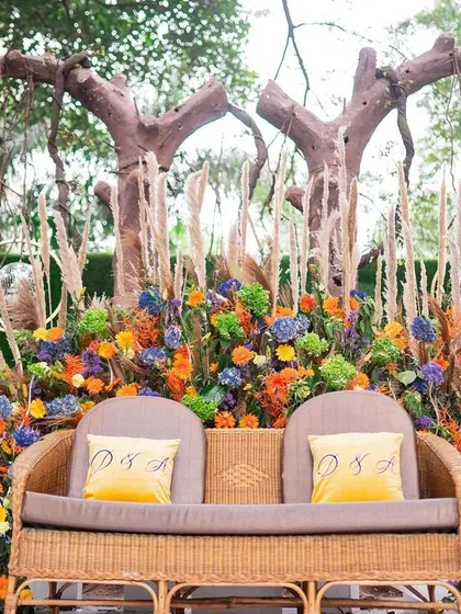 A closer view of the Mehendi stage, showing the personalized cushions and the intricate mix of flowers and textures. Every detail is carefully considered to fit the theme.