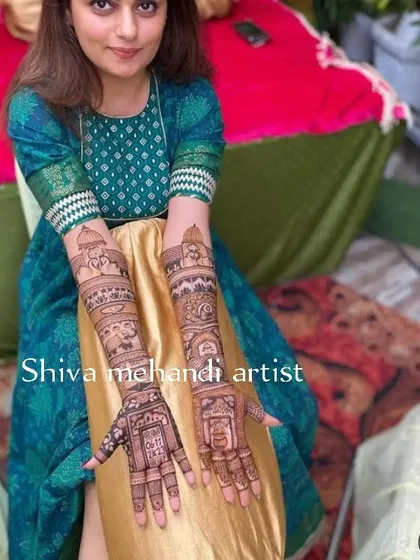 This client is all smiles with her wedding story mehendi, which narrates her special day through intricate illustrations on her arms.