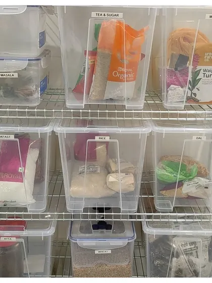 Clear, stackable bins are perfect for organizing backstock in your pantry. By labeling each bin with categories like 'Tea & Sugar' or 'Breakfast', you always know what you have and what you need to replenish.