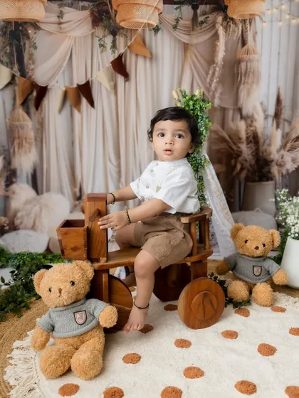 A handsome portrait of the little brother with his teddy bears during the sibling session.
