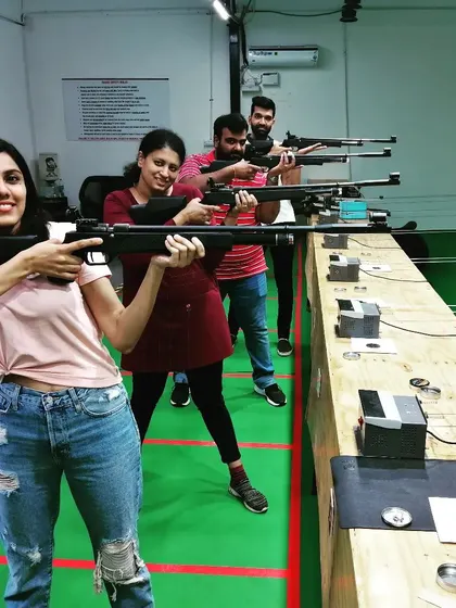 A shooter enjoying her first time with an air rifle. I'm always there to guide you, making sure the experience is safe, comfortable, and exciting.