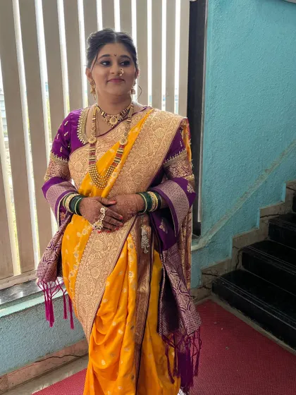 My bride Saloni, looking absolutely radiant in her yellow and purple Paithani saree. I provided the complete look, including makeup, hair, and draping.
