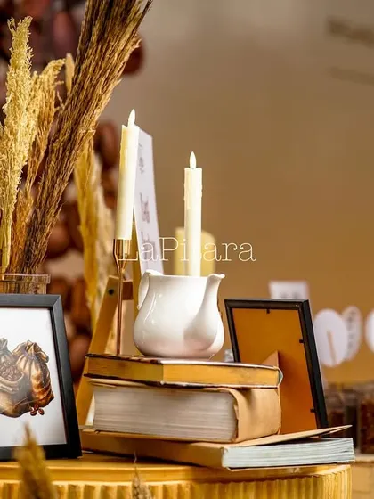 A quiet, studious corner we styled with books, candles, and framed art. These small, thoughtful arrangements create pockets of visual interest throughout the event space.