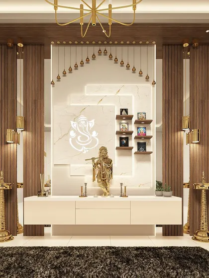 This divine pooja unit serves as a spiritual sanctuary in the home. The design features a marble backdrop with a Ganesha motif, traditional brass lamps, and elegant wood pillars, blending tradition with sophistication.