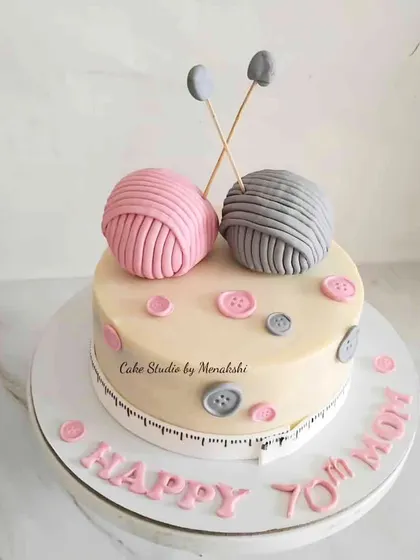A sweet knitting themed cake for a mom's 70th birthday. I handcrafted the balls of yarn, knitting needles, and little buttons to celebrate her favorite hobby.