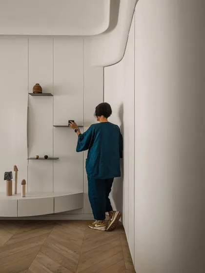 A personal moment of arranging details in the master bedroom, showing the care and thought that goes into every corner.